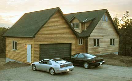 Image of the rear exterior of the model C-510 chalet design showing garage, doors and back of the house.